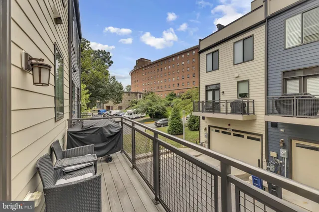 a view of a balcony with chairs and wooden floor