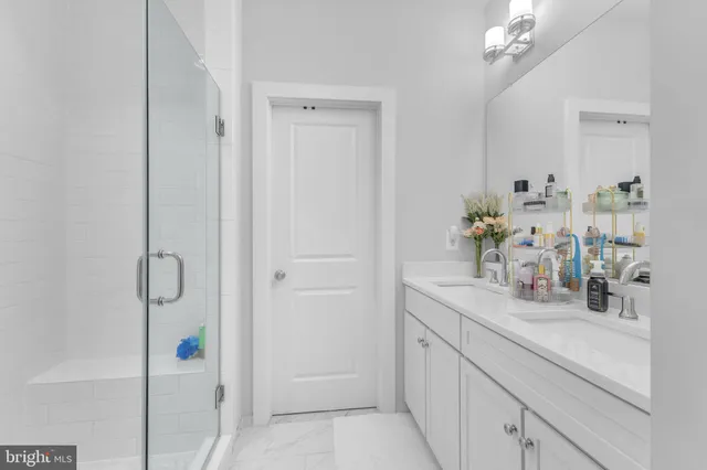 a bathroom with cabinets and mirror