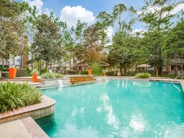 a view of yard with swimming pool and green space