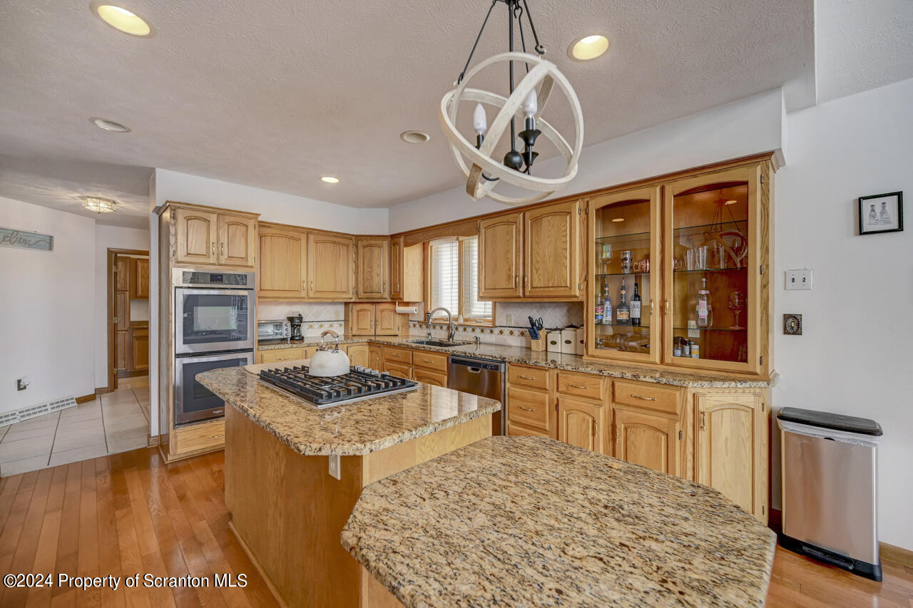 428 Point Road Lake Winola, PA 18419 - Photo 17 of 74 a kitchen with stainless steel appliances granite countertop a sink stove and refrigerator