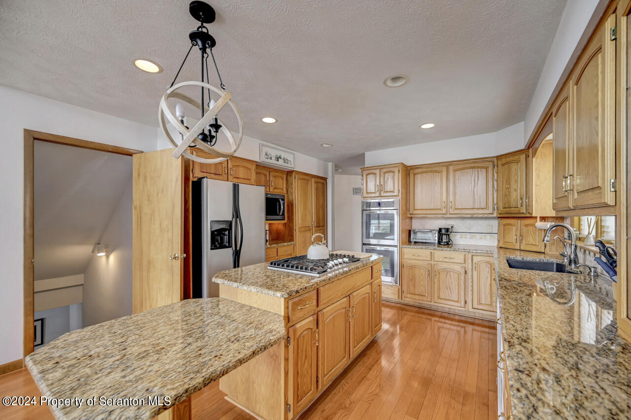 428 Point Road Lake Winola, PA 18419 - Photo 18 of 74 a kitchen with stainless steel appliances granite countertop a sink stove and refrigerator
