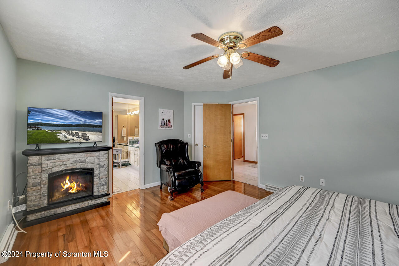 428 Point Road Lake Winola, PA 18419 - Photo 20 of 74 a bedroom with a bed and a fireplace