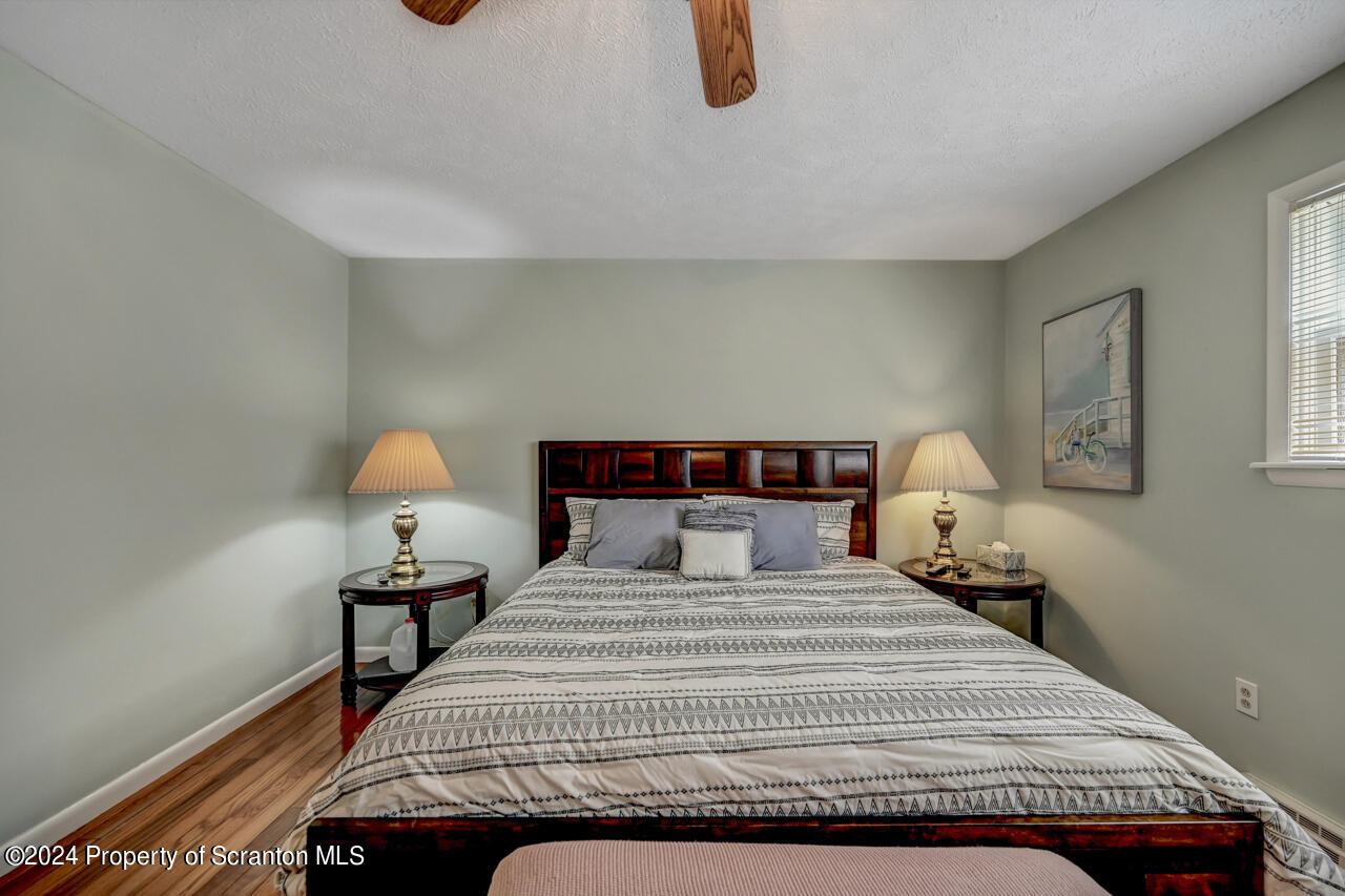 428 Point Road Lake Winola, PA 18419 - Photo 21 of 74 a bedroom with a bed and a lamp on table