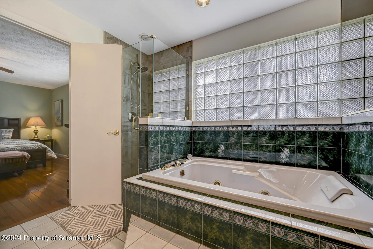 428 Point Road Lake Winola, PA 18419 - Photo 24 of 74 a bathroom with a bathtub and shower
