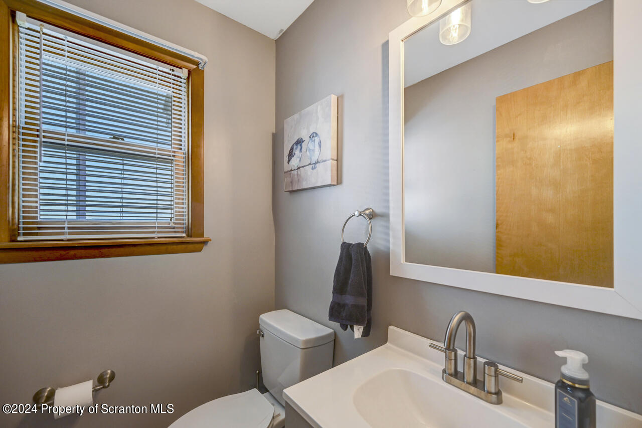 428 Point Road Lake Winola, PA 18419 - Photo 27 of 74 a bathroom with a toilet sink and mirror