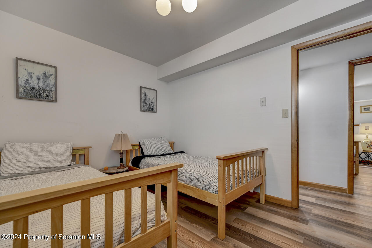 428 Point Road Lake Winola, PA 18419 - Photo 45 of 74 a bedroom with a bed and wooden floor