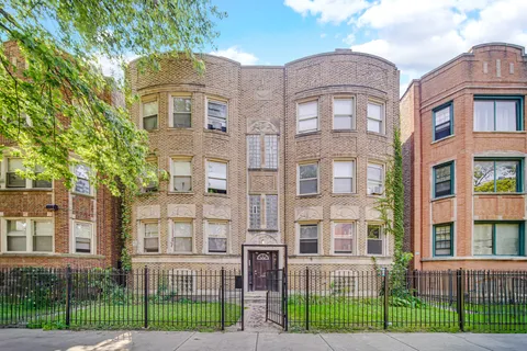 front view of a brick building next to a yard