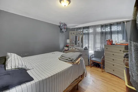 a bedroom with a bed and a mirror