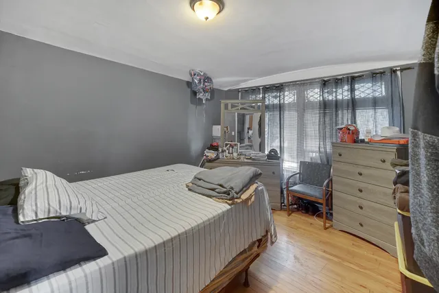 a bedroom with a bed and a mirror