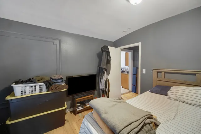 a bedroom with a bed and a dresser