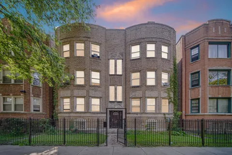outdoor view of a brick building next to a yard