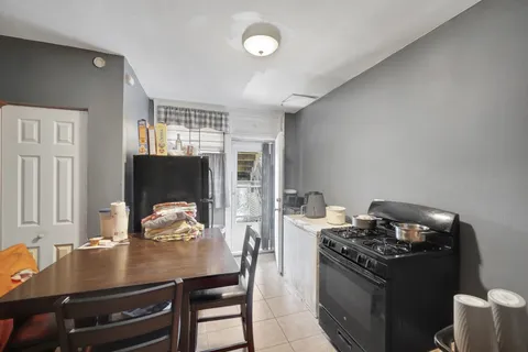 a kitchen with a stove and a refrigerator