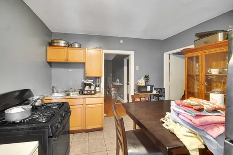 a kitchen with a stove and a dining table