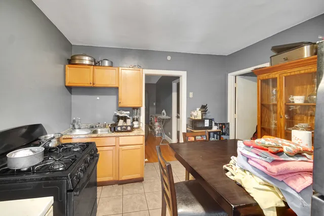 a kitchen with a stove and a dining table