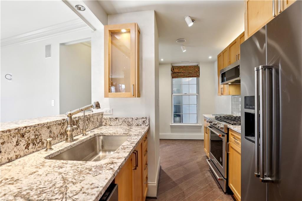 3101 Howell Mill Road Northwest, Unit 121 Atlanta, GA 30327 - Photo 14 of 40 a kitchen with a sink stove top oven and refrigerator