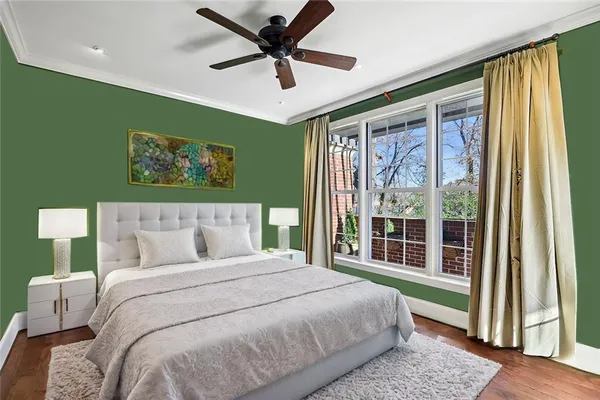 a bedroom with a bed and a large window