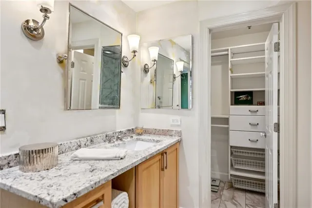 a bathroom with a granite countertop sink and a mirror