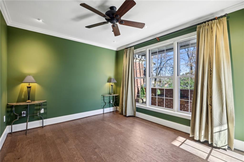 3101 Howell Mill Road Northwest, Unit 121 Atlanta, GA 30327 - Photo 16 of 40 a view of a livingroom with a ceiling fan and a window