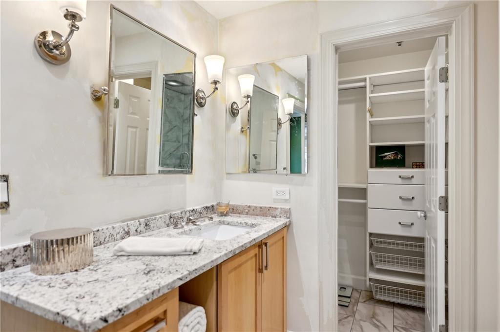 3101 Howell Mill Road Northwest, Unit 121 Atlanta, GA 30327 - Photo 19 of 40 a bathroom with a granite countertop sink and a mirror