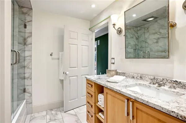 a bathroom with a granite countertop sink and a mirror