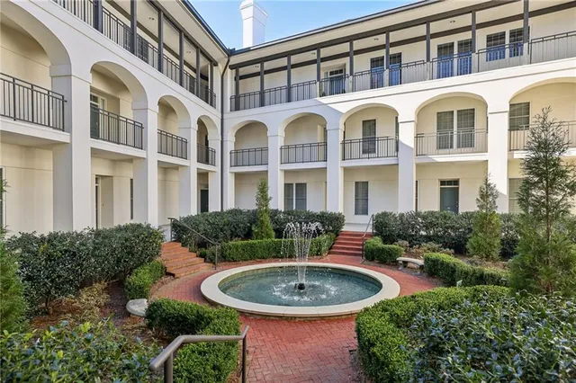 a view of a brick building next to a yard