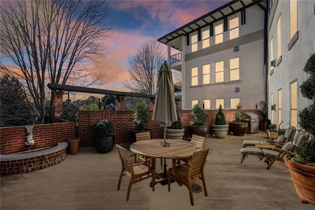 a view of a patio with a table and chairs
