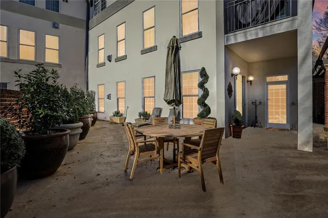 a view of a patio with dining table and chairs