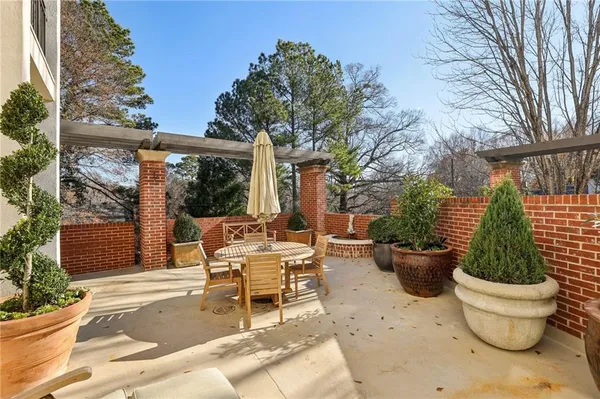 a view of a patio with couches and potted plants