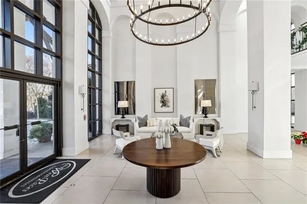 a living room with furniture a rug and a chandelier