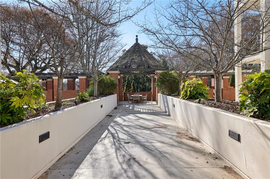 3101 Howell Mill Road Northwest, Unit 121 Atlanta, GA 30327 - Photo 36 of 40 a view of a house with a small yard