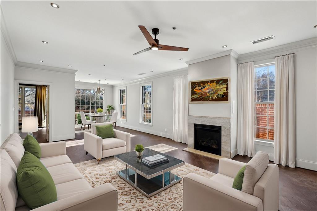 3101 Howell Mill Road Northwest, Unit 121 Atlanta, GA 30327 - Photo 4 of 38 a living room with furniture and a fireplace