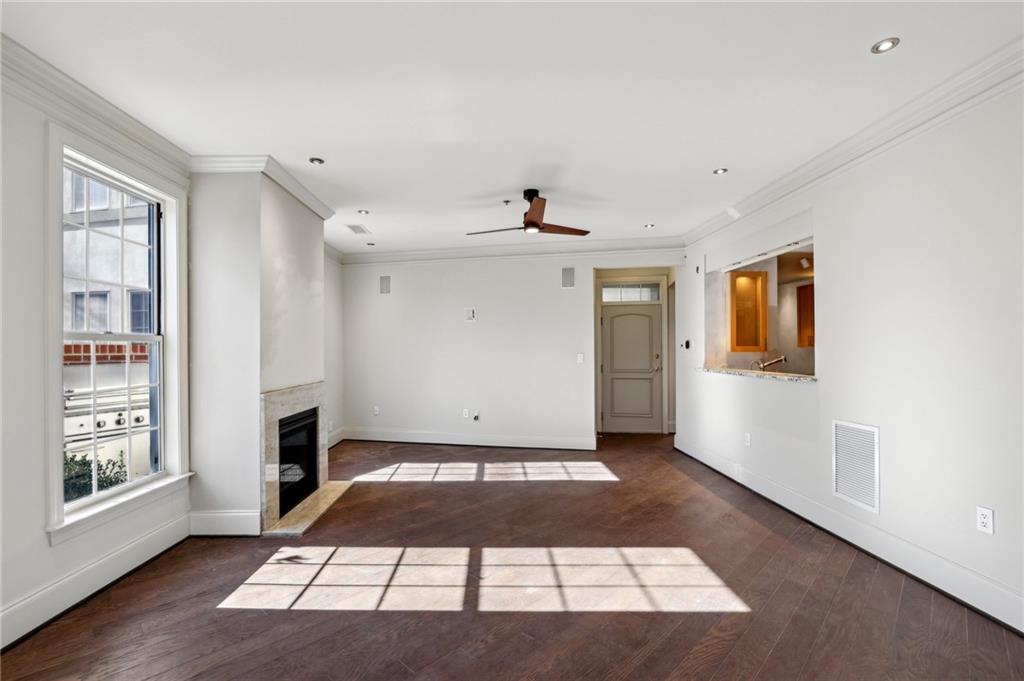 3101 Howell Mill Road Northwest, Unit 121 Atlanta, GA 30327 - Photo 7 of 38 a view of a livingroom with wooden floor and a cabinet