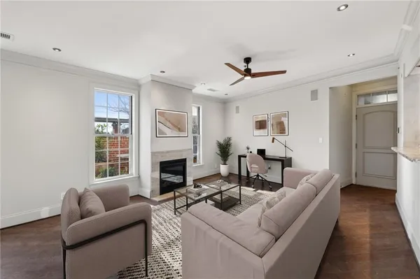 a living room with furniture a fireplace and a flat screen tv