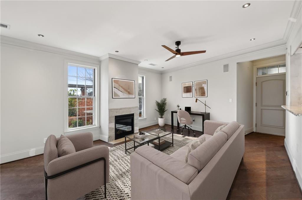 3101 Howell Mill Road Northwest, Unit 121 Atlanta, GA 30327 - Photo 7 of 40 a living room with furniture a fireplace and a flat screen tv