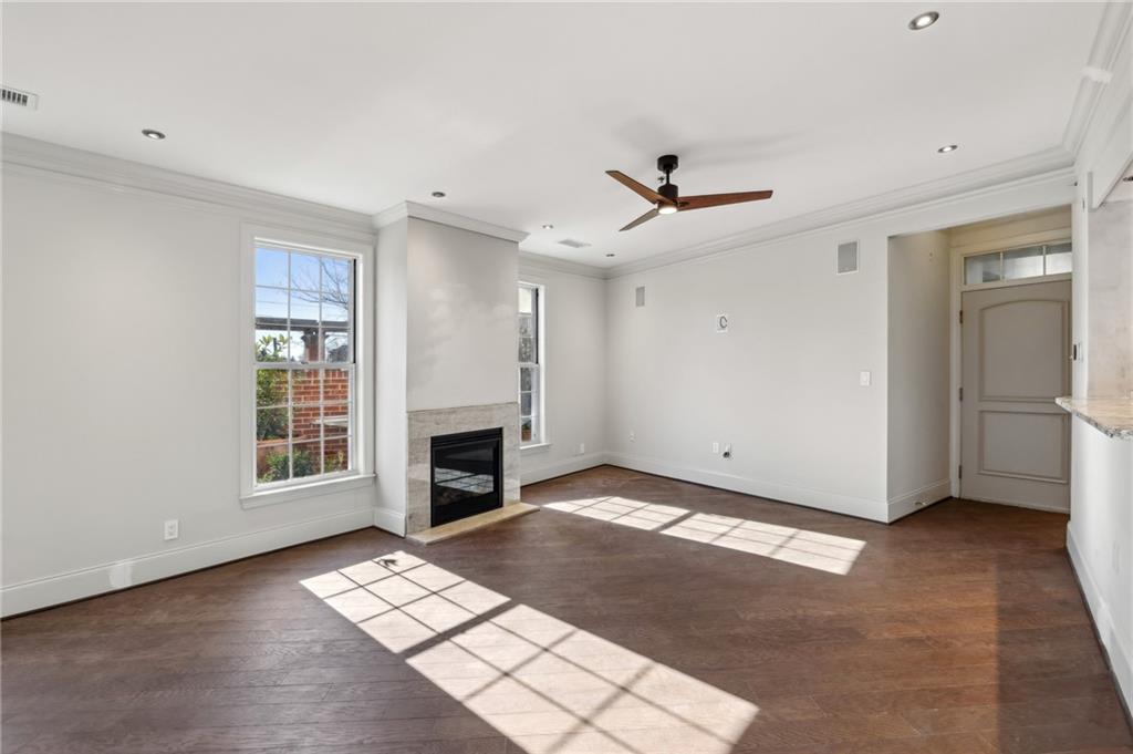 3101 Howell Mill Road Northwest, Unit 121 Atlanta, GA 30327 - Photo 7 of 40 a view of livingroom with window ceiling fan and hardwood floor