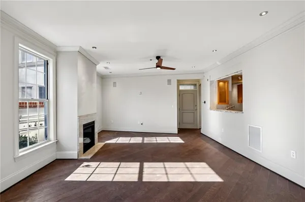 a view of a livingroom with wooden floor and a cabinet