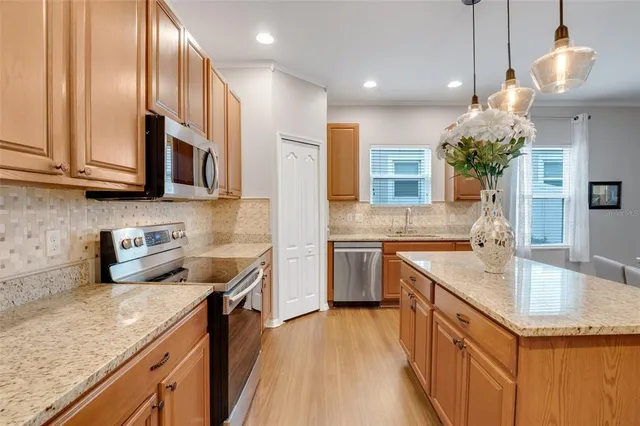 a kitchen with a sink stove and microwave