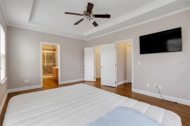 a bedroom with a bed and a flat screen tv