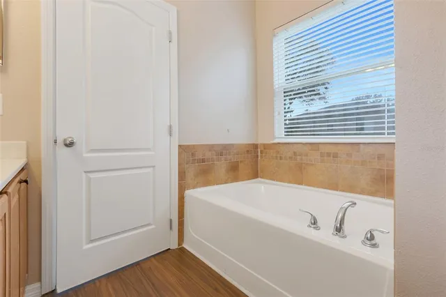 a white bath tub sitting next to a window