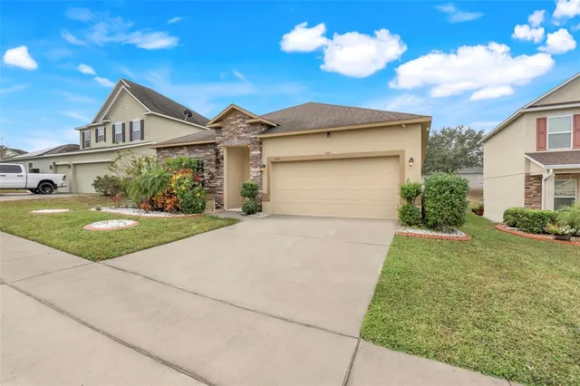 a front view of a house with a yard and garage