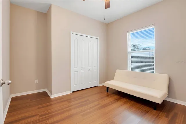 a spacious bedroom with a bed and a window