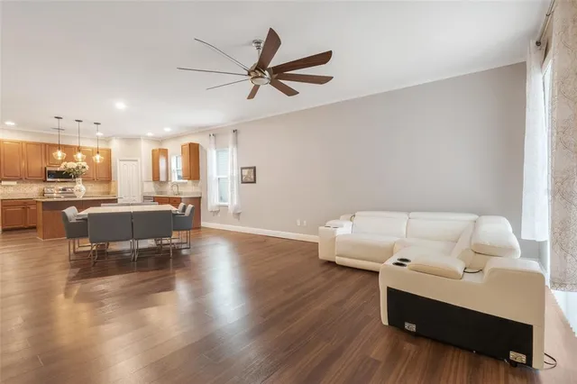 a living room with furniture and kitchen view