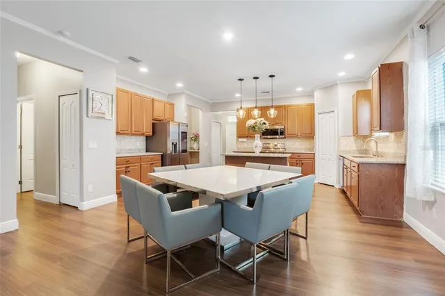 a kitchen with stainless steel appliances kitchen island granite countertop a sink and cabinets