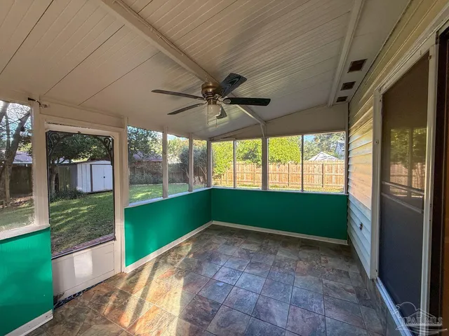a view of porch with a floor to ceiling window and a yard