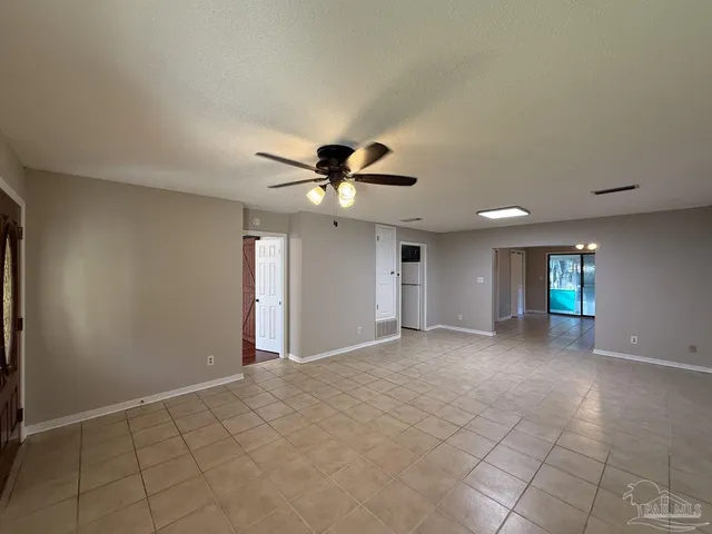a view of a livingroom with a ceiling fan and window