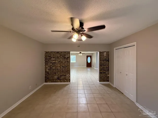 a view of an empty room with a ceiling fan