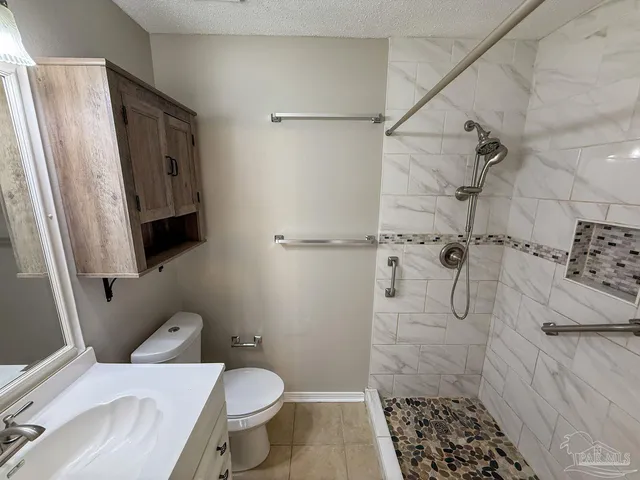 a bathroom with a toilet and shower