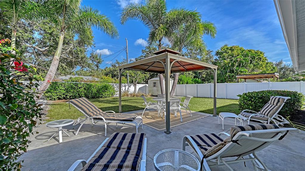 2115 Grove Street Sarasota, FL 34239 - Photo 14 of 40 a view of backyard with seating space and wooden fence