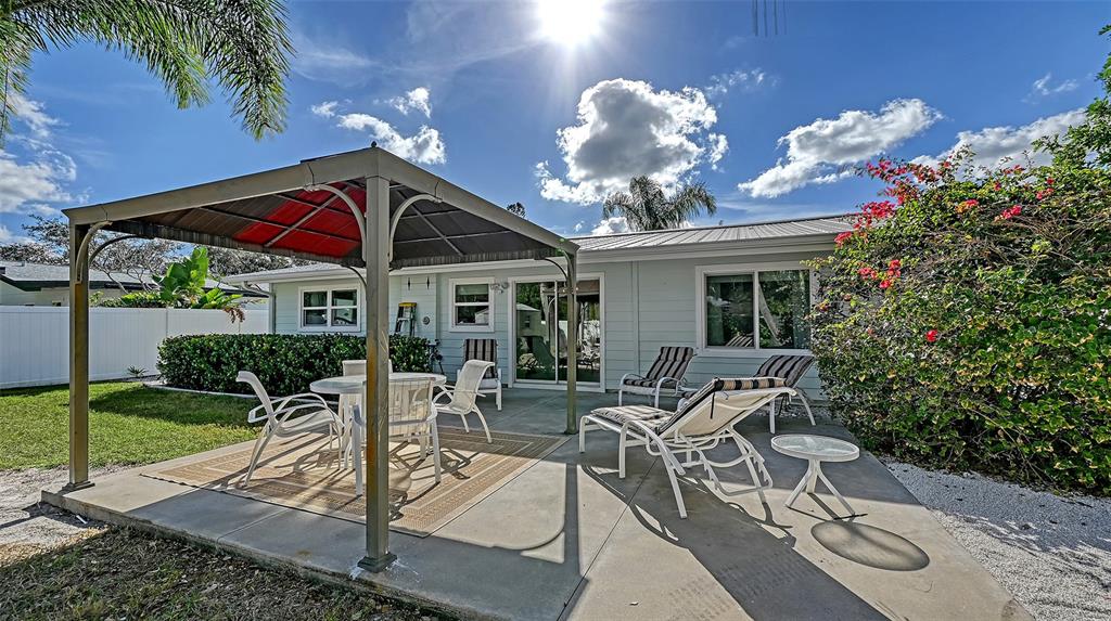 2115 Grove Street Sarasota, FL 34239 - Photo 15 of 40 a view of a patio with table and chairs potted plants