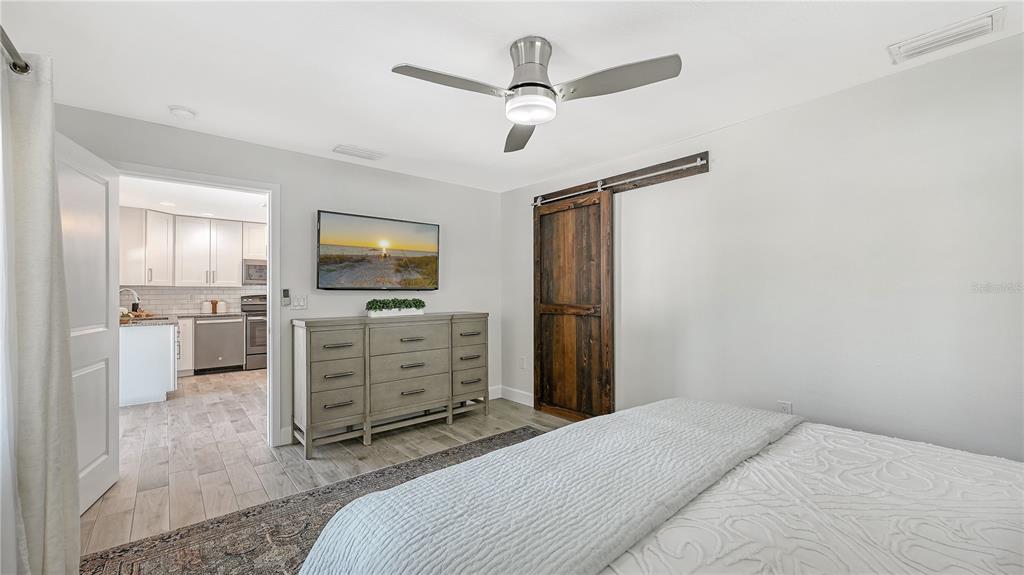 2115 Grove Street Sarasota, FL 34239 - Photo 17 of 40 a bedroom with a bed dresser and a flat tv screen